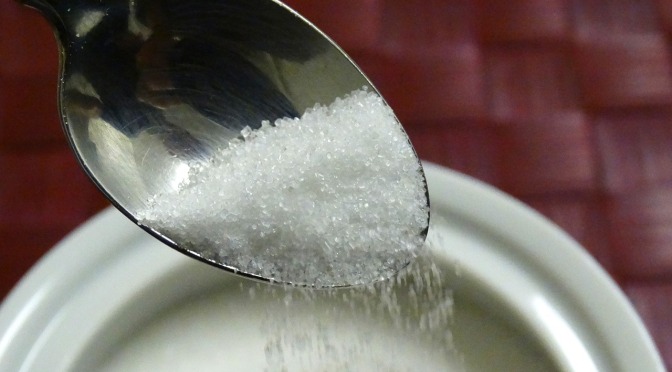 a teaspoon spooning sugar from a bowl