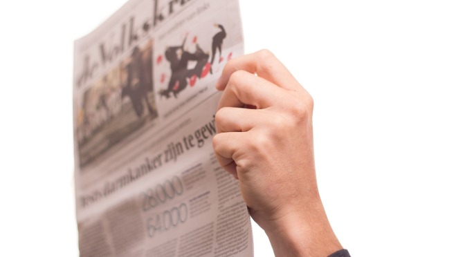 hand holding newspaper