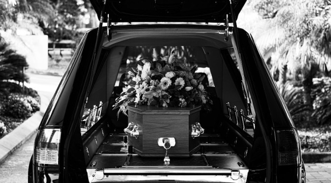 hearse with casket and flowers
