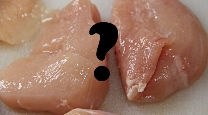 raw chicken breasts with a question mark